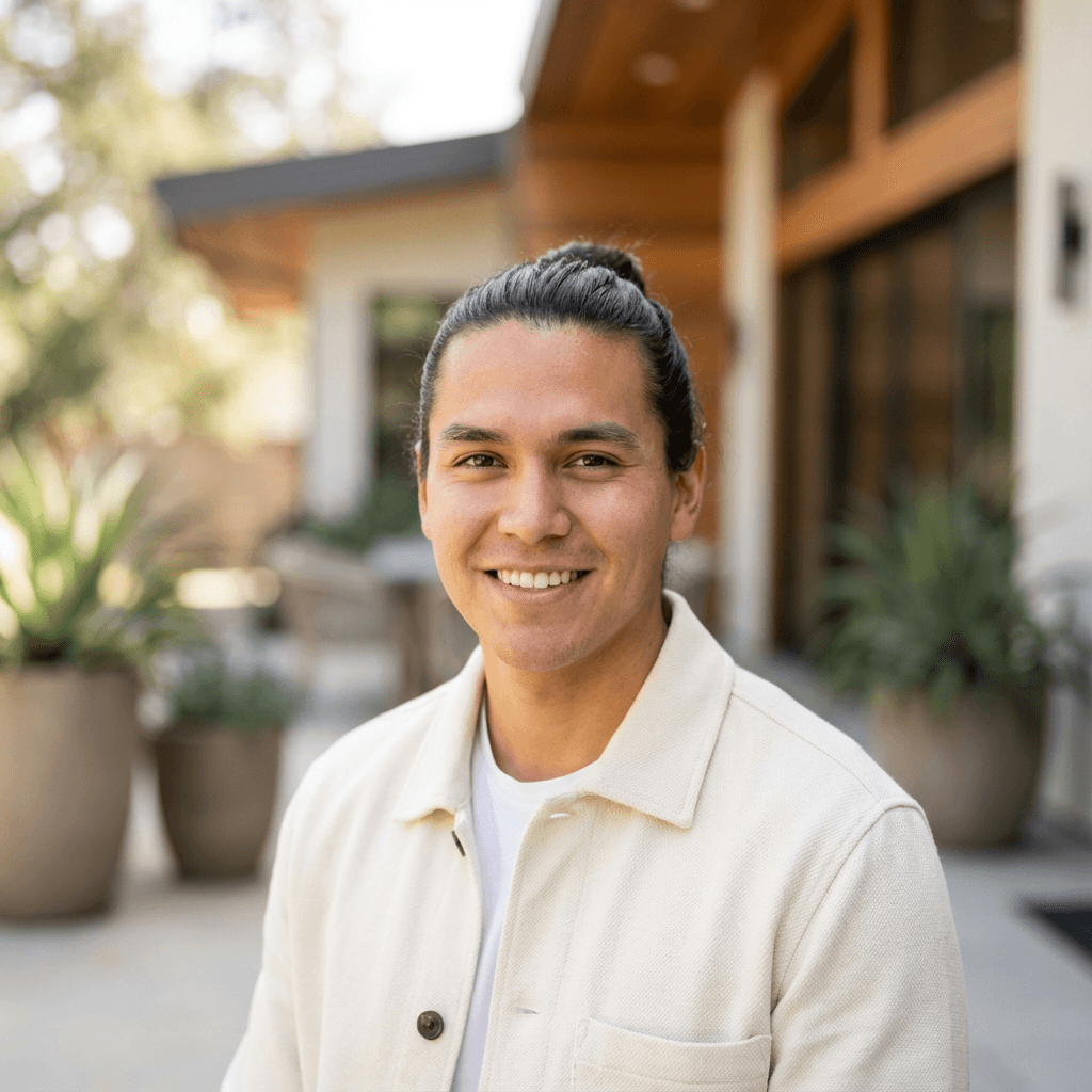 Male student in his early 20s, South Asian, focused and sincere expression, wearing a volunteer vest