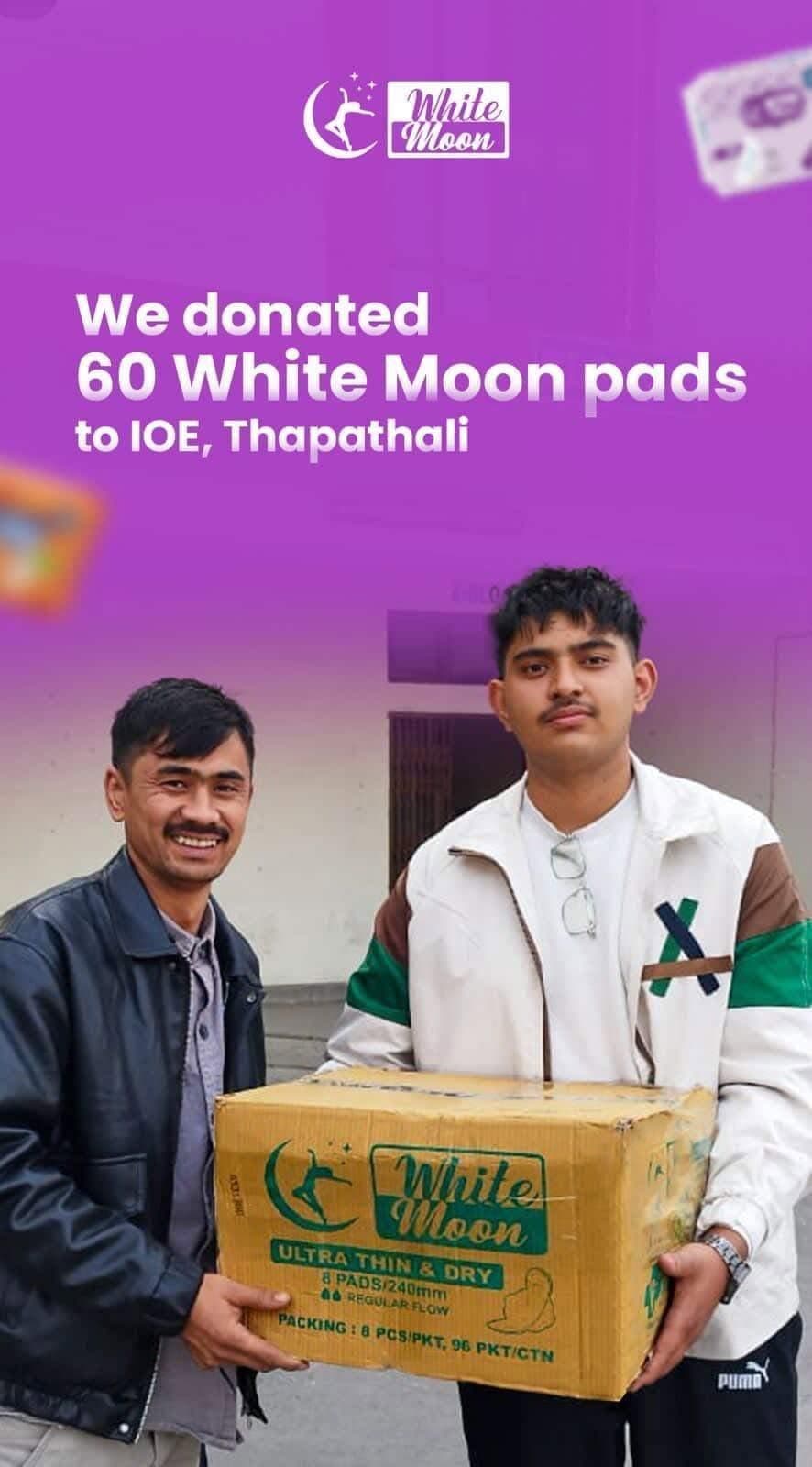 Two men holding a box of White Moon sanitary pads donated to IOE, Thapathali.